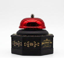 Red service bell with black base featuring 'Brickhouse Inn' branding on a white background