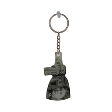 A keychain featuring a silhouette of the Lizzie Borden House with an axe head design.