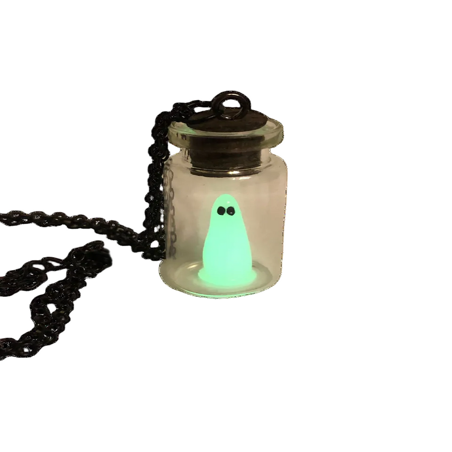 A glow-in-the-dark pendant featuring a green ghost inside a glass bottle, suspended by a black chain.