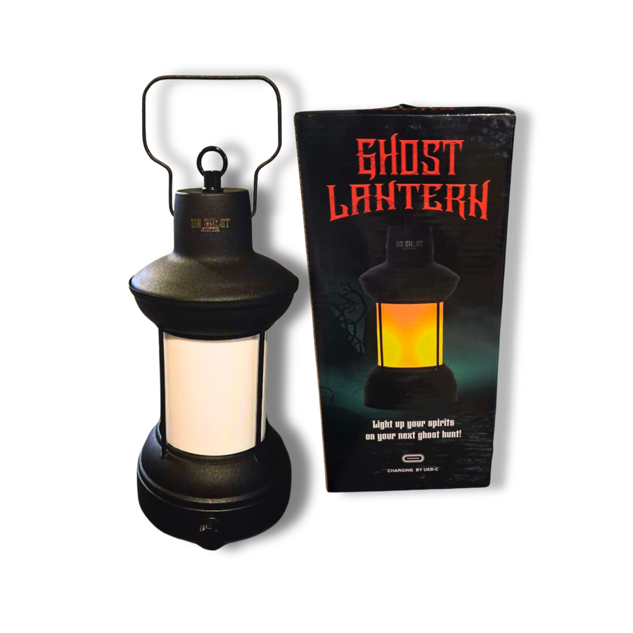 Black lantern with glowing interior next to its packaging on a white background