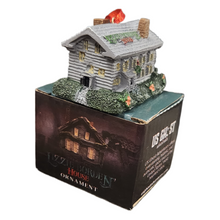 Decorative house ornament on a box with 'Us Ghost Adventures" branding