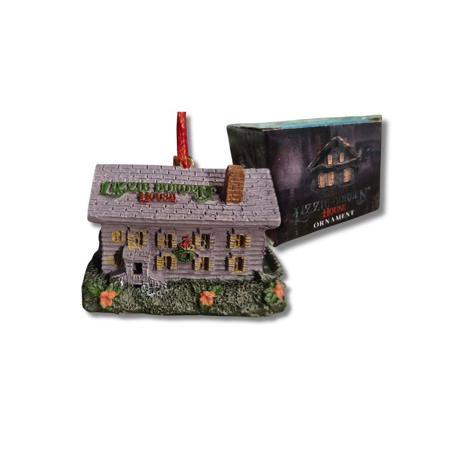 Ornament of a haunted house Lizzie Borden sign, next to its packaging on a white background.